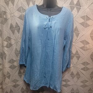 Hannah size large blue blouse with string tie front and lace in sleeves.